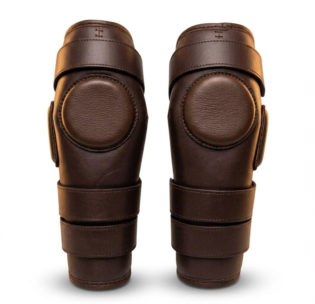 Pair of brown genuine leather polo knee guards with foam padded disc by Best Horse