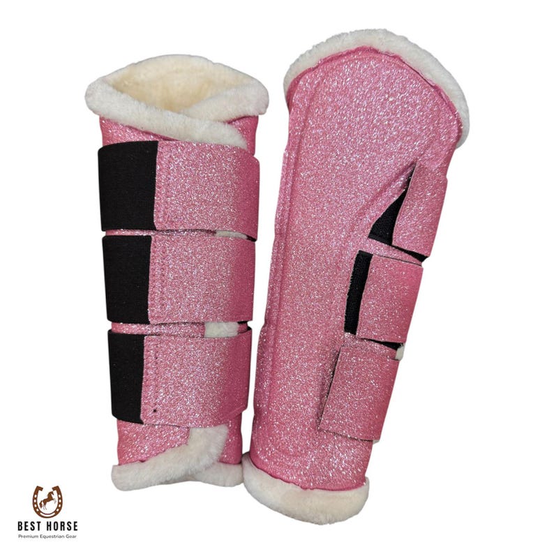 Pair of pink glitter horse brushing boots with white fleece lining and three straps