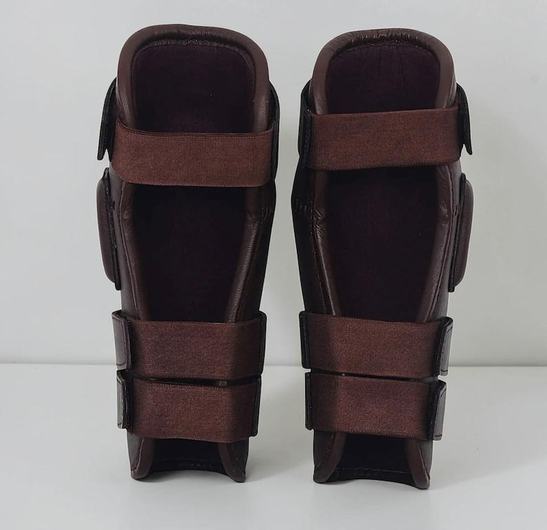 Inside of leather polo knee guards showing soft lining and hook-and-loop straps