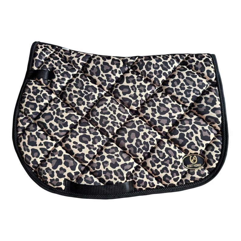 Tan leopard print all-purpose saddle pad with black rope cord binding